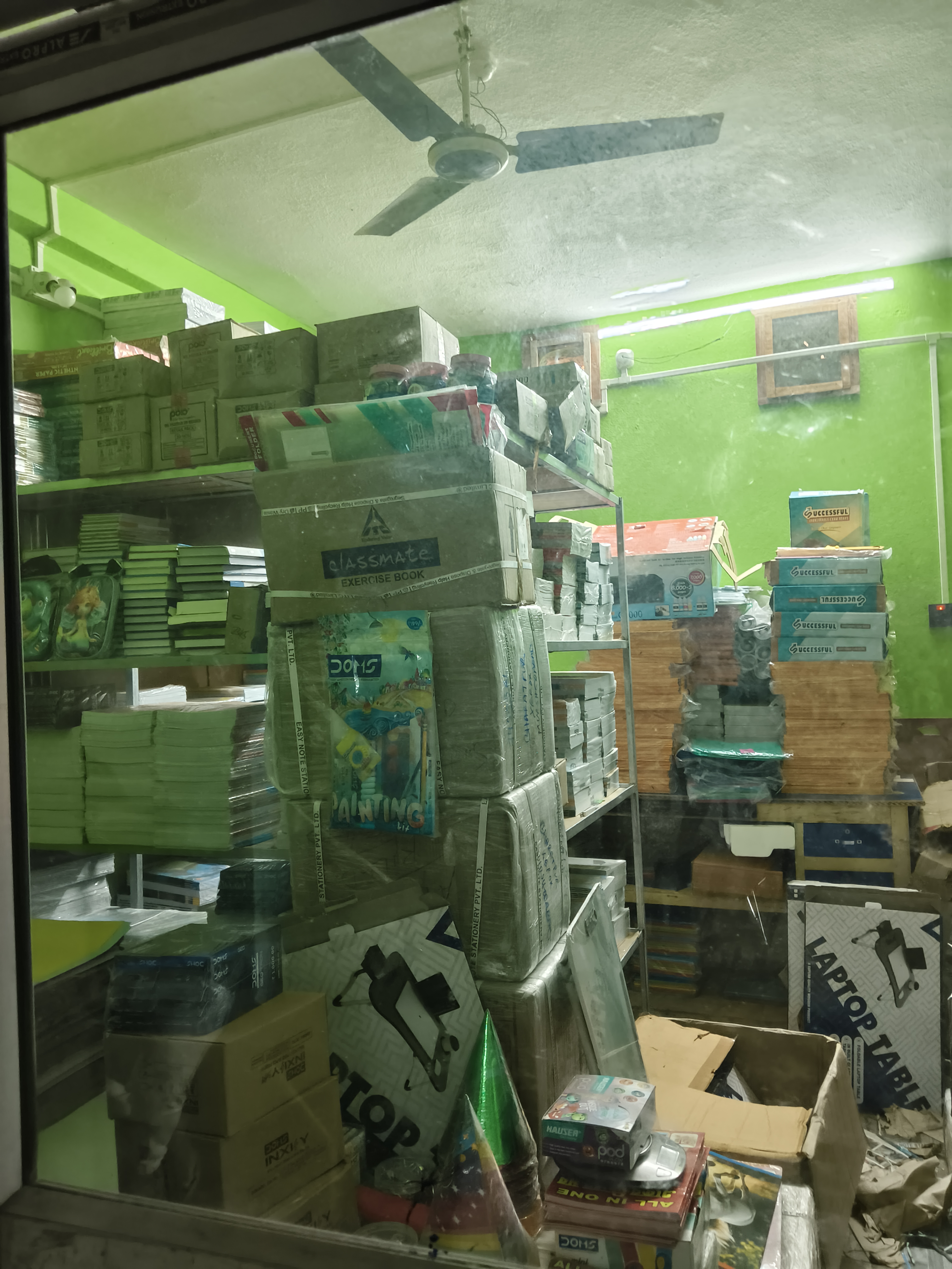 Shelves stacked with notebooks and paper